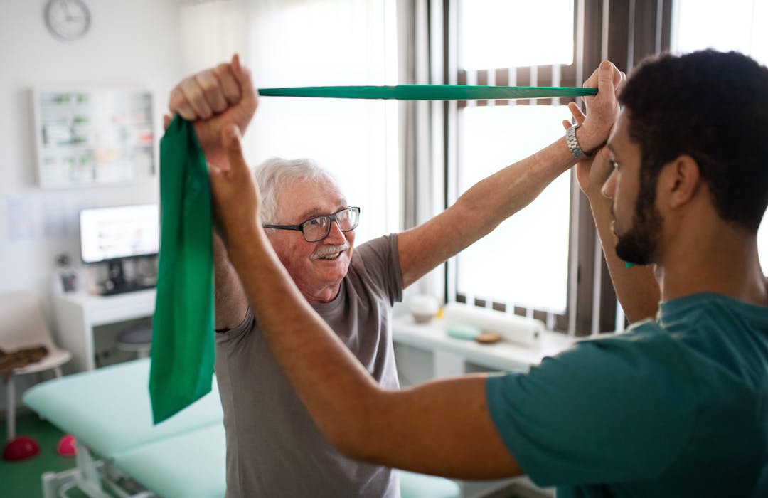 Old Man stretching with exercise band